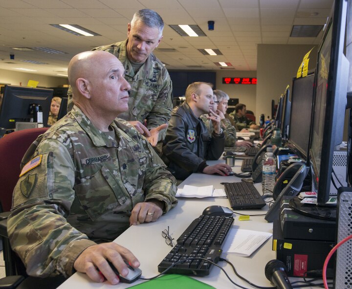 U.S. Airmen from the 9th Air Force, based at Shaw Air Force Base, S.C., and U.S. Soldiers, Sailors, and Airmen from the Joint Enabling Capabilities Command, Naval Station Norfolk, Va., discuss options to present a joint solution during the Joint Task Force-9 Staff Exercise 18-3 at Shaw AFB, March 7, 2018.