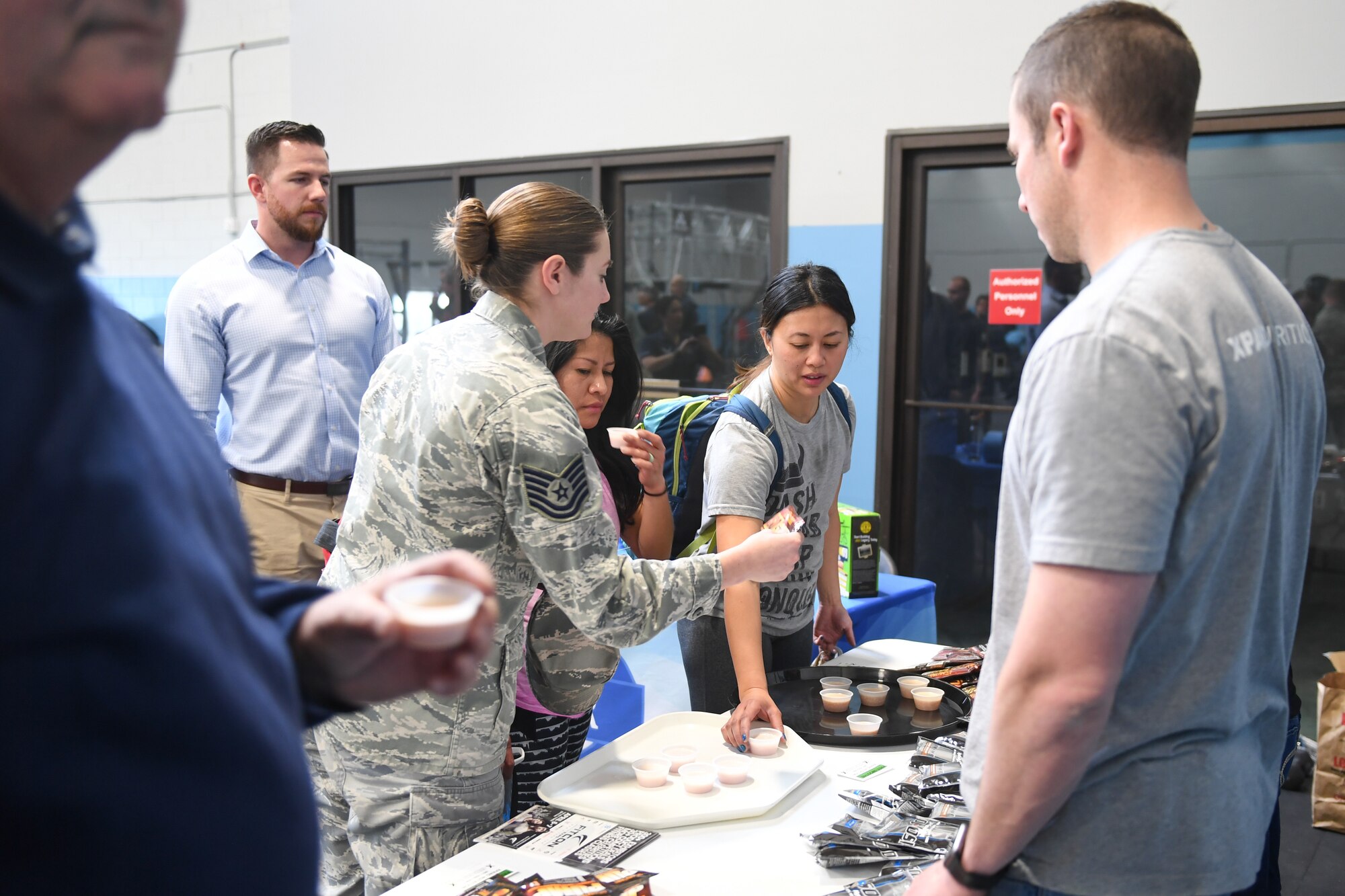 Attendees at the March 27, 2018, grand opening of the Hess Fitness Center's new functional training area at Hill Air Force Base, Utah, grab free protein shake samples. (U.S. Air Force photo by Cynthia Griggs)