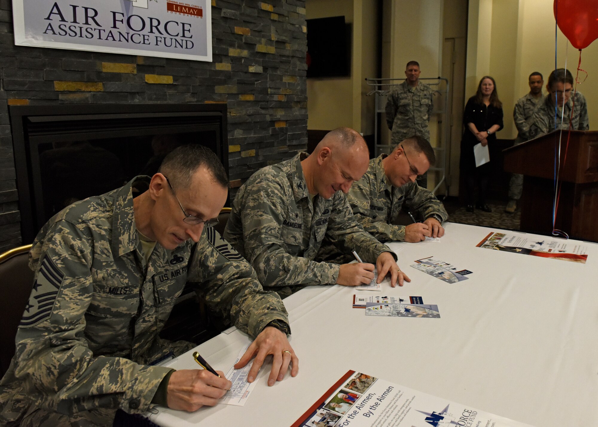 (from left) Chief Master Sgt. Lee Mills, 92nd Air Refueling Wing command chief, Col. Ryan Samuelson, 92nd ARW commander, and Col. J. Scot Heathman, 92nd ARW vice commander, make the first donations during the Air Force Assistance Fund kick-off breakfast at Fairchild Air Force Base, Washington, March 26, 2018. The Air Force Aid Society directs the AFAF and works to support and enhance the U.S. Air Force mission by providing emergency financial assistance, education support and community programs to Airmen. (U.S. Air Force photo/Airman 1st Class Jesenia Landaverde)