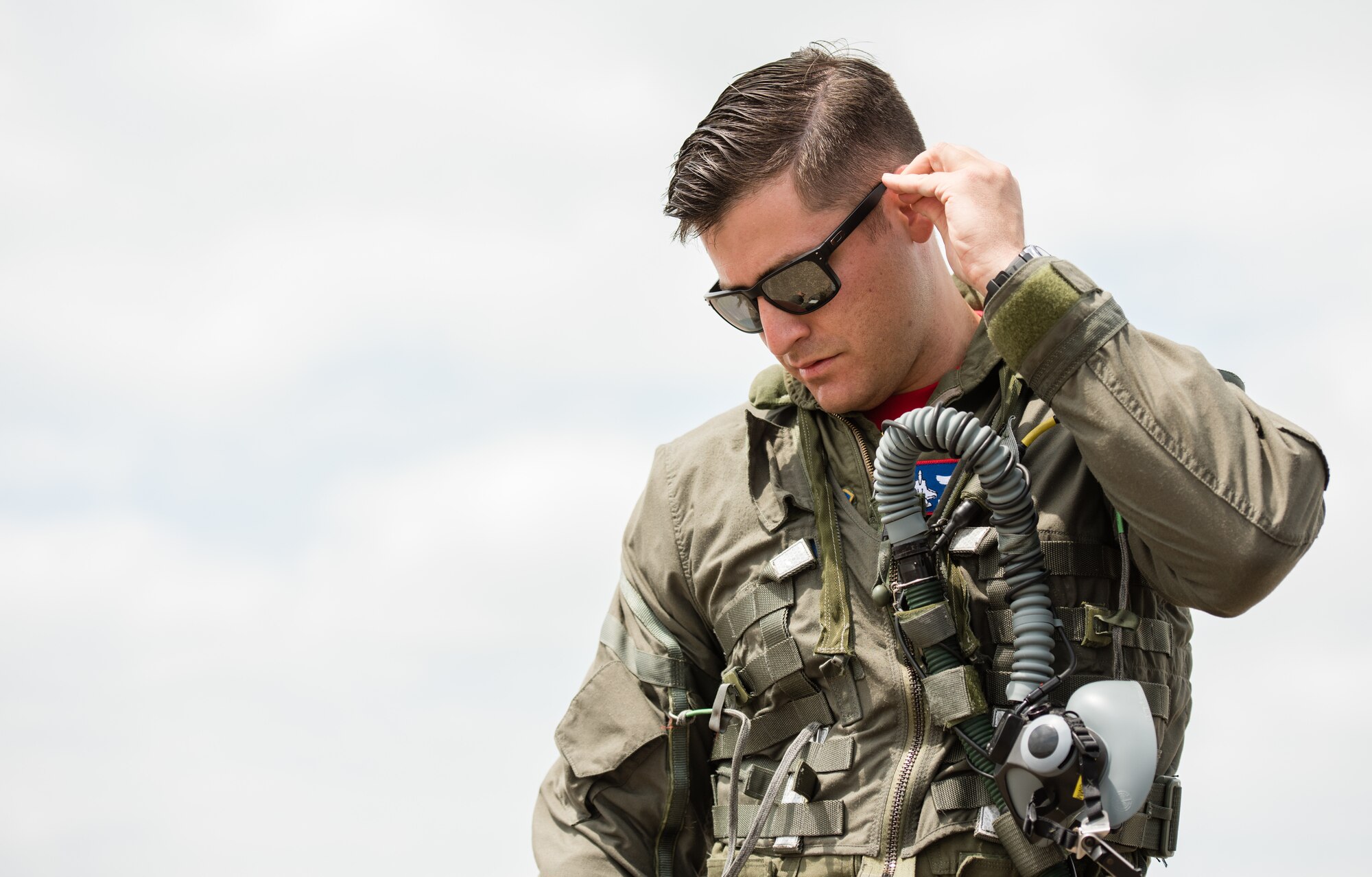 Capt. Andrew “Dojo” Olson, F-35 Heritage Flight Team pilot, prepares his gear before flight during the Wings Over South Texas air show at Naval Air Station Kingsville, Texas, March 24, 2018. The F-35 HFT includes one pilot and 12 maintainers, a compilation of Active Duty, Reserve, and Guard Airmen. (U.S. Air Force photo by Airman 1st Class Alexander Cook)