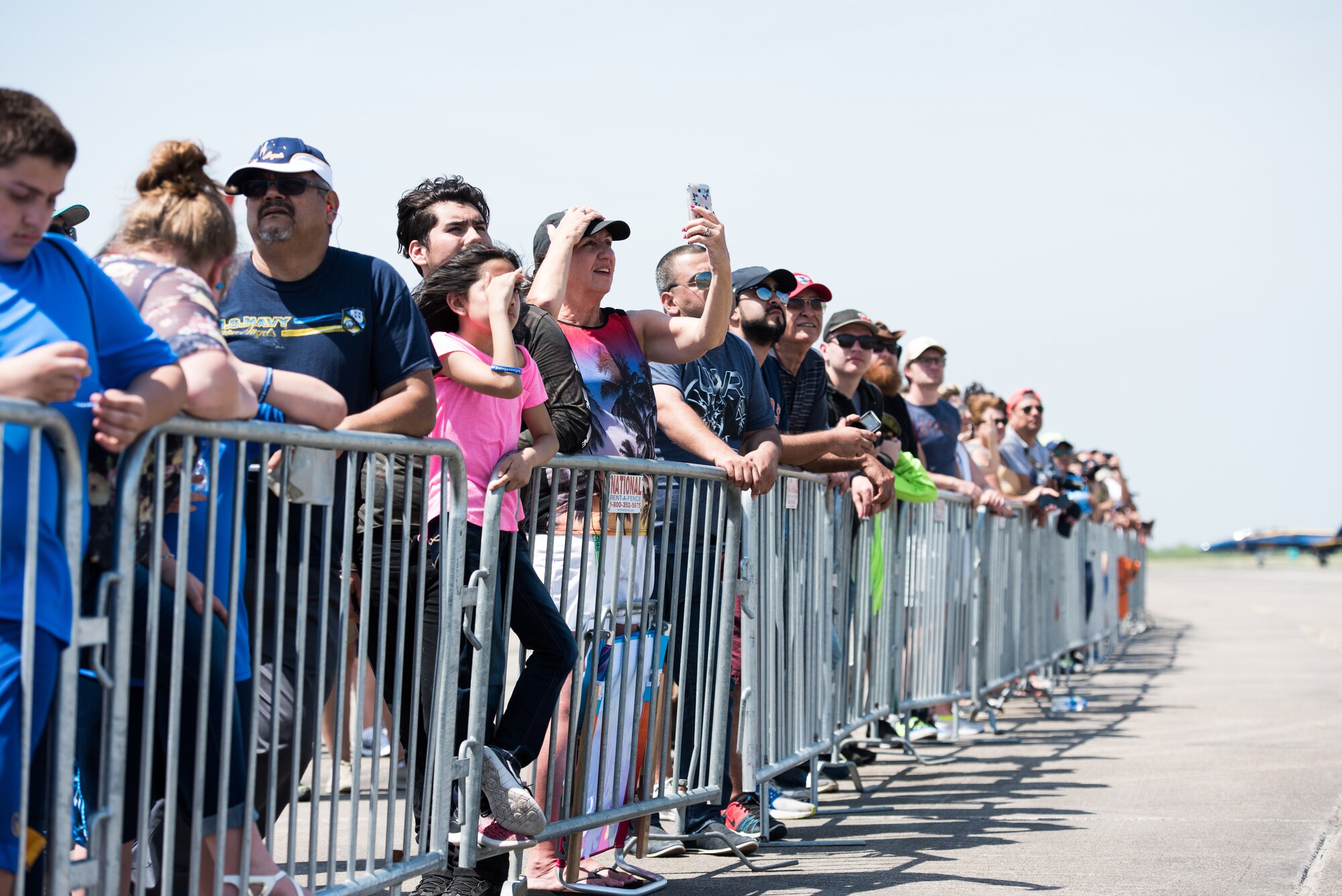 A crowd of air show guests view the F-35 Heritage Flight Team Demonstration during the Wings Over South Texas air show at Naval Air Station Kingsville, Texas, March 25, 2018. During the two-day event, approximately 100,000 guests from all across the United States attended the WOST air show. (U.S. Air Force photo by Airman 1st Class Alexander Cook)
