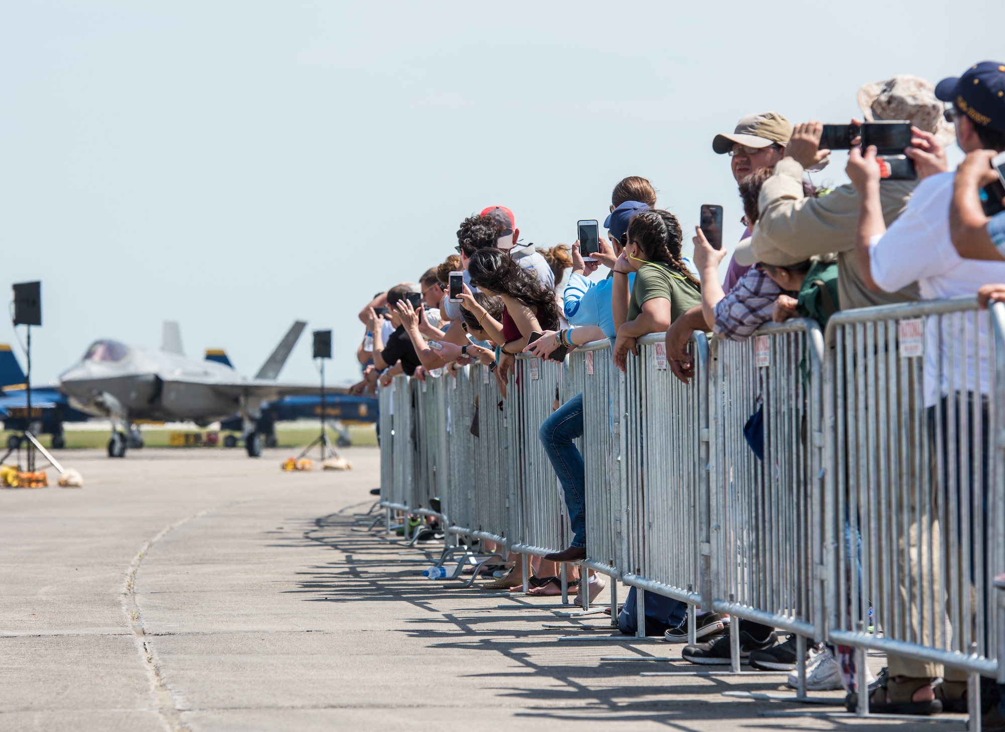 A crowd of air show guests watch as the F-35 Lightning II taxis down the runway during the Wings Over South Texas air show at Naval Air Station, Texas, March 25, 2018. During the two-day event, approximately 100,000 guests from all across the United States attended the WOST air show. (U.S. Air Force photo by Airman 1st Class Alexander Cook)