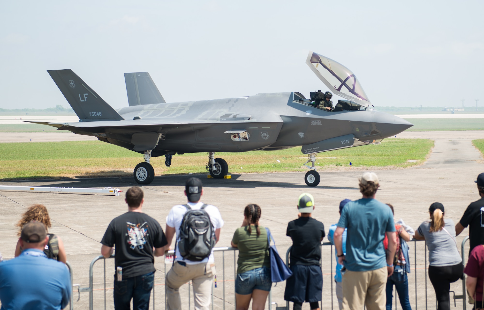 Air show guests watch as Capt. Andrew “Dojo” Olson, F-35 Heritage Flight Team pilot, prepares for a flight in an F-35 Lightning II during the Wings Over South Texas air show at Naval Air Station, Texas, March 25, 2018. Throughout the air show season, the F-35 HFT will perform at 13 air shows around the world. (U.S. Air Force photo by Airman 1st Class Alexander Cook)