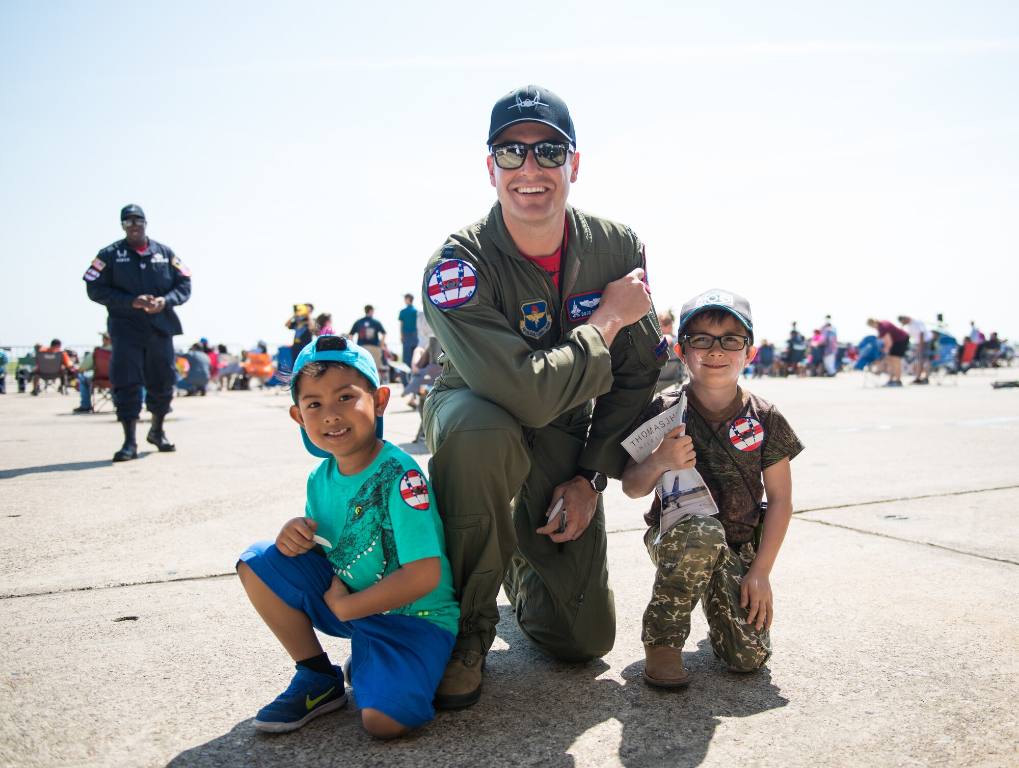 Capt. Andrew “Dojo” Olson, F-35 Heritage Flight Team pilot, poses for a photo with air show guests during the Wings Over South Texas air show at Naval Air Station, Texas, March 25, 2018. During the two-day event, approximately 100,000 guests from all across the United States attended the WOST air show. (U.S. Air Force photo by Airman 1st Class Alexander Cook)