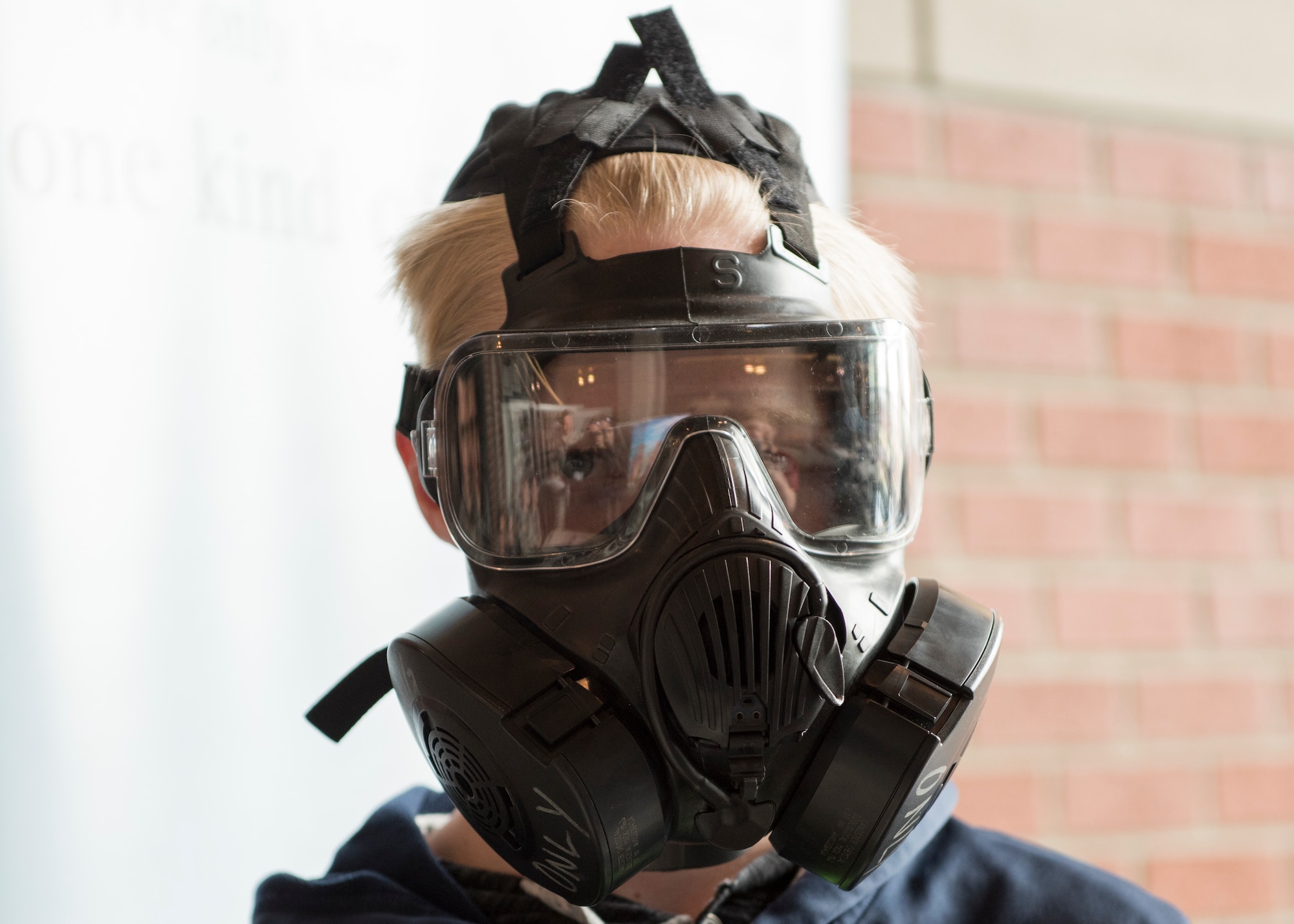 Dustin Ylitalo, Deer Park Middle School student, tries on a M50 gas mask at an informational booth during the  Eastern Washington Regional Science and Engineering Fair at the Spokane Washington State University campus, Washington, March 15, 2018. Members of Team Fairchild attended the fair to provide visiting students with information about the science, technology, engineering and math related fields that the U.S. Air Force offers. (U.S. Air Force photo/Senior Airman Ryan Lackey)