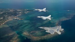A U.S. Air Force 44th Fighter Squadron F-15 Eagle and U.S. Navy Strike Fighter Squadron 27 and 102 (VFA-27, VFA-102) F/A-18 Super Hornets, assigned to Naval Air Facility Atsugi, Japan, fly in formation after a training sortie Feb. 16, 2017, over the Pacific Ocean. The joint training bolstered communications and interoperability between the two services, which both serve to enhance peace and security throughout the Indo-Asia Pacific Theater. (U.S. Air Force photo by Staff Sgt. Peter Reft/Released)