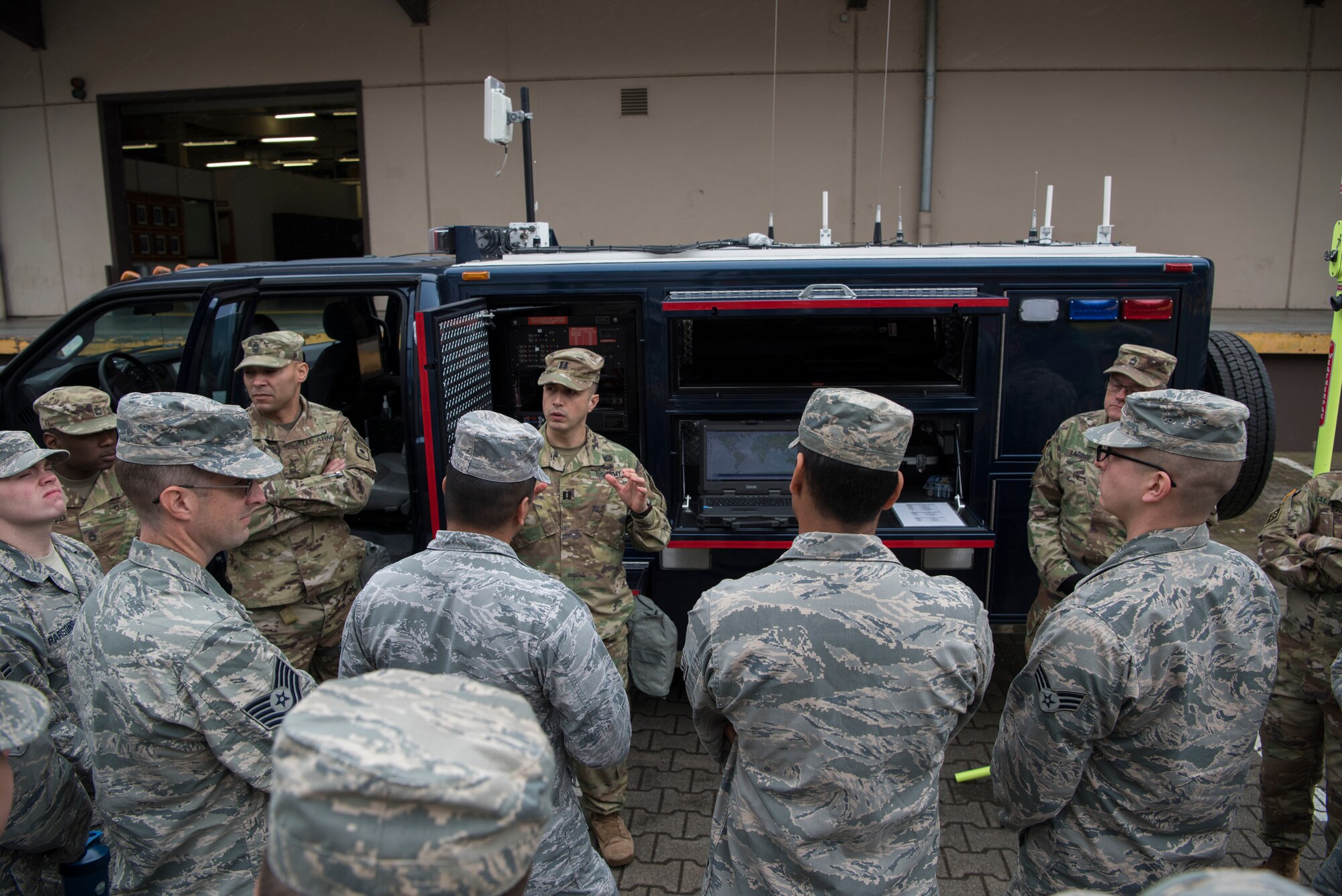 U.S. Army Capt. Dino De La Hoya, 773rd Civil Support Team operations officer in charge, explains to Airmen and Army Reserve personnel the function of the Advanced Echelon Vehicle during the 786th Civil Engineer Squadron and 773rd Civil Support Team interoperability demonstration on Ramstein Air Base, Germany, March 12, 2018. This vehicle offers quick reaction communication capability allowing commanders to disseminate assessment of an incident scene, advise a response, and facilitate access to Department of Defense information in support of the First Responder Incident Commander.