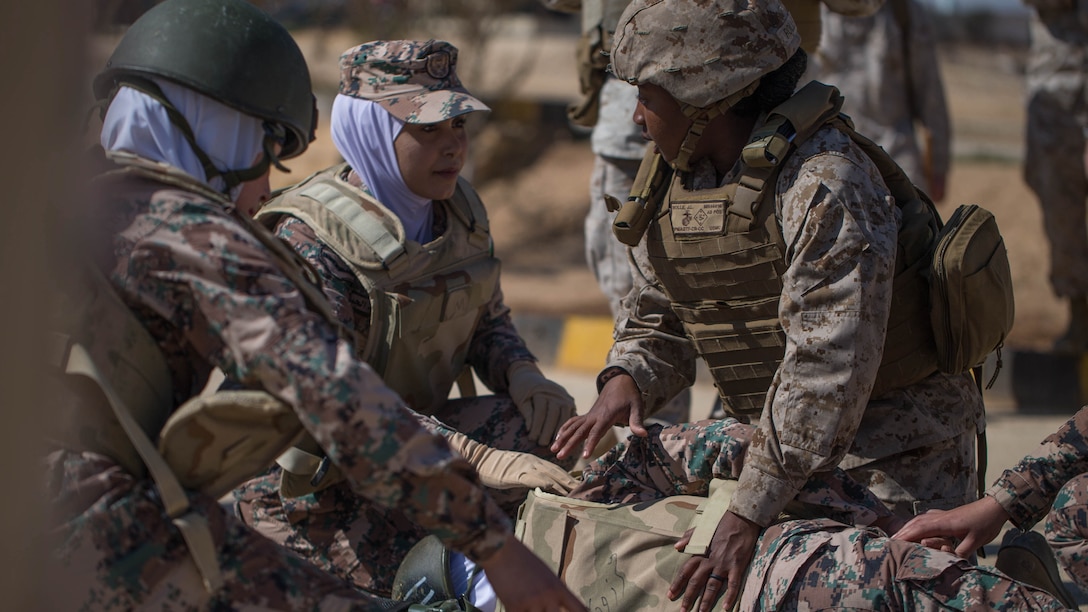 Female Marine teaches life saving tactics.