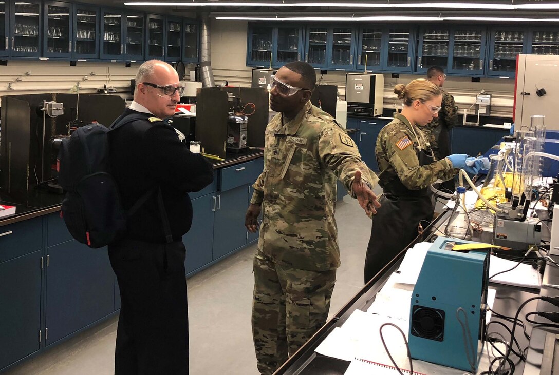 Staff Sgt. Robert McGee explains testing to French Le Service des Essences des Armées officer Major Mathieu Picquenard.