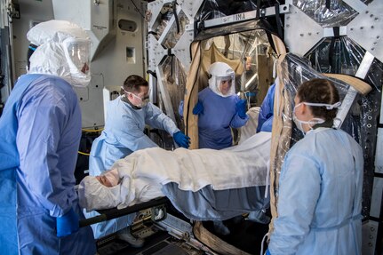 Air Mobility Command Airmen load a patient into the transportable isolation system during a training event at Joint Base Charleston, S.C., March 14, 2018.