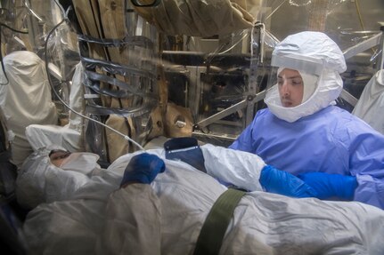 Tech. Sgt. Gregory Izzi, 43rd Aeromedical Evacuation Squadron medical technician, checks the vital signs of a patient during a transportable isolation system training event at Joint Base Charleston, S.C., March 14, 2018.