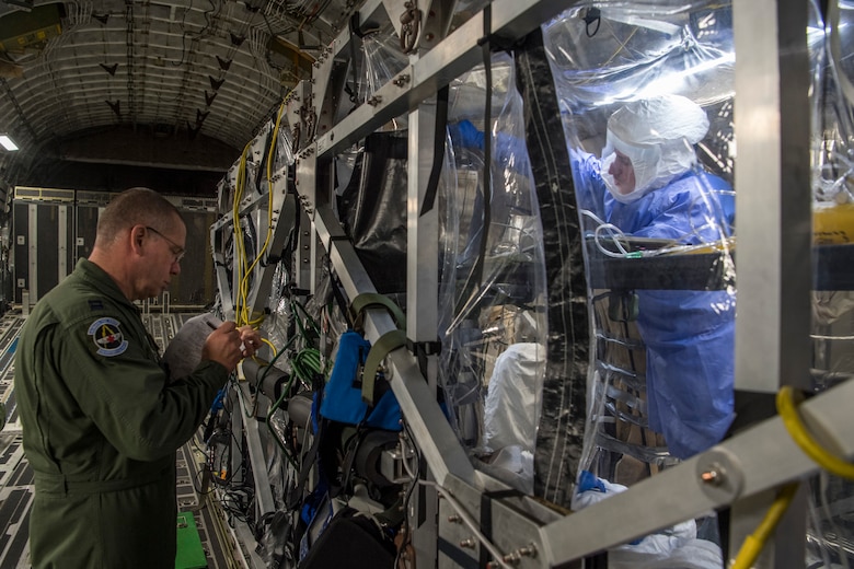 Tech. Sgt. Gregory Izzi, 43rd Aeromedical Evacuation Squadron medical technician, receives instructions for patient care during a transportable isolation system training event at Joint Base Charleston, S.C., March 14, 2018.