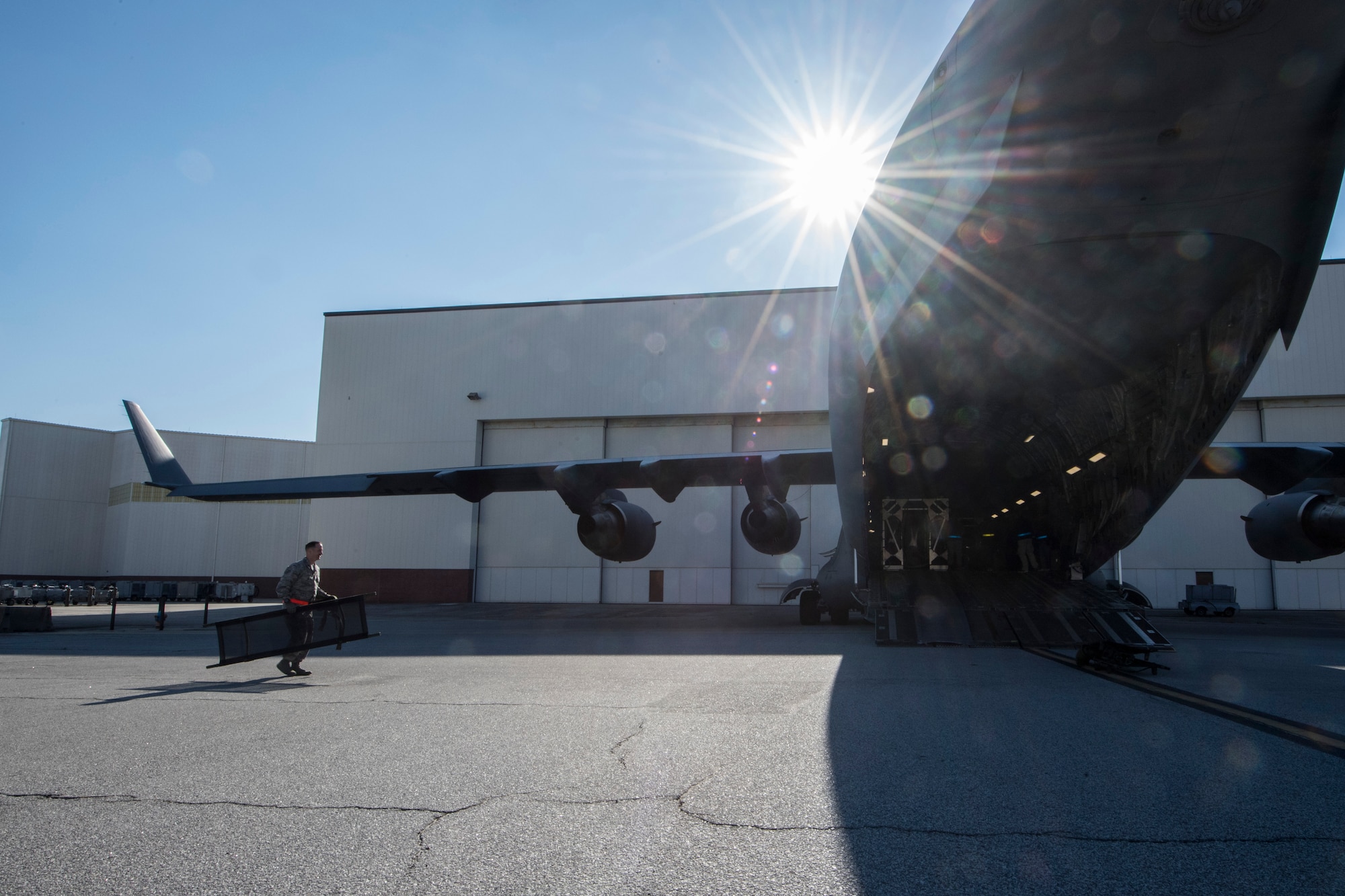 An Air Mobility Command Airman carries a gurney during a transportable isolation system training and research event at Joint Base Charleston, S.C., March 14, 2018.