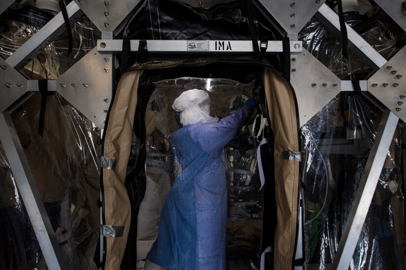 Tech. Sgt. Gregory Izzi, 43rd Aeromedical Evacuation Squadron medical technician, prepares the transportable isolation system during a training and research event at Joint Base Charleston, S.C., March 14, 2018.