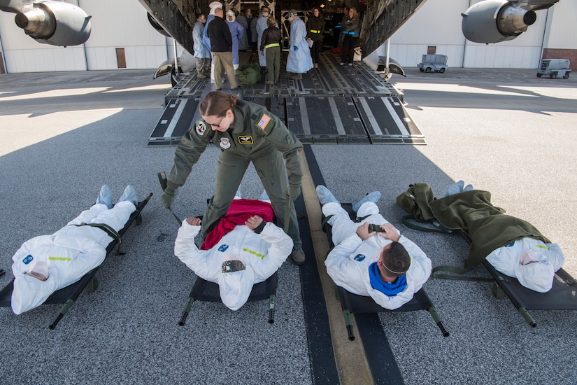 Capt. Robyn Fredregill, 43rd Aeromedical Evacuation Squadron flight nurse, prepares patients during a transportable isolation system scenario at Joint Base Charleston, S.C., March 14, 2018.
