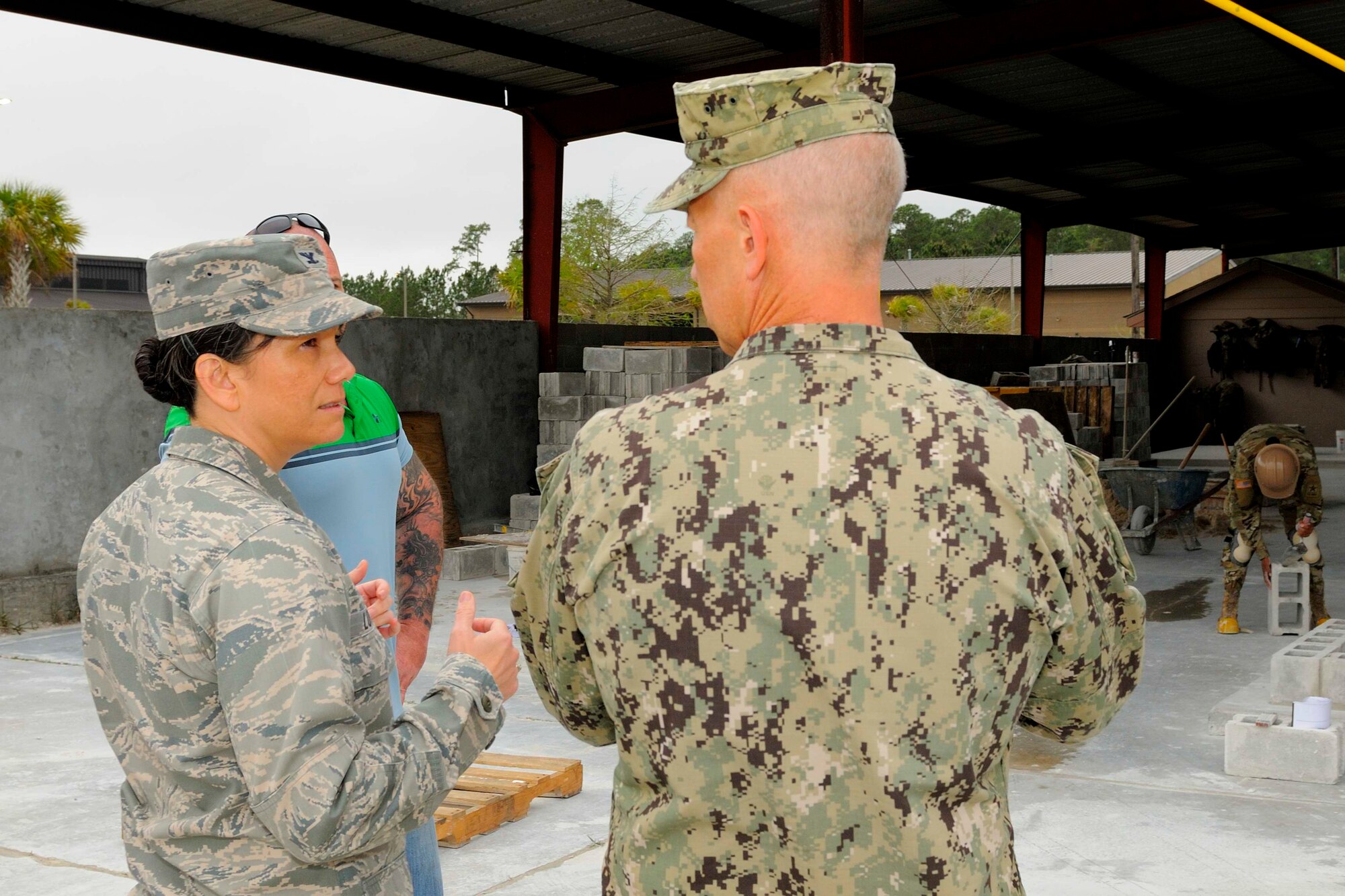 U.S. Air Force Col. Debra Lovette, 81st Training Wing commander, speaks with U.S. Navy Capt. William Whitmire, Naval Construction Battalion Center commanding officer, Gulfport, Mississippi, March 27, 2018, on NCBC, Mississippi. Lovette toured NCBC Gulfport facilities to learn more about the joint-service construction training performed at the neighboring Gulf Coast base. (U.S. Navy photo by Ryan Labadens)