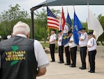 A Vietnam veteran pays his respects during the posting of the colors by the Fort Sam Houston Memorial Services Detachment at the beginning of the ceremony for the 50th Anniversary of the Commemoration of the Vietnam War at the Fort Sam Houston National Cemetery March 27.