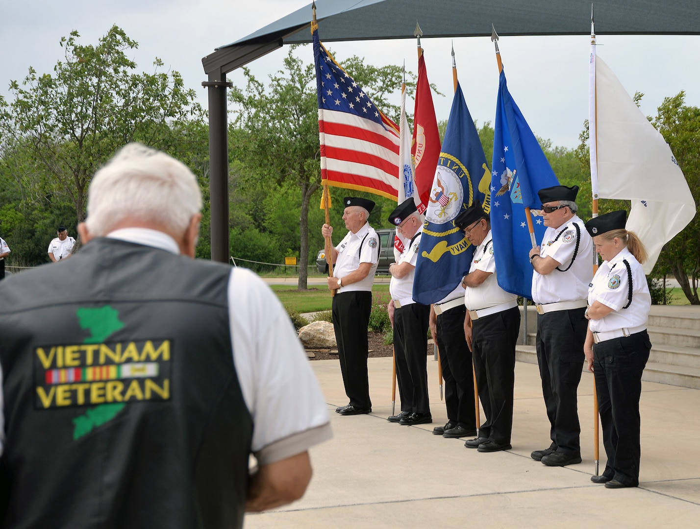 A Vietnam veteran pays his respects during the posting of the colors by the Fort Sam Houston Memorial Services Detachment at the beginning of the ceremony for the 50th Anniversary of the Commemoration of the Vietnam War at the Fort Sam Houston National Cemetery March 27.