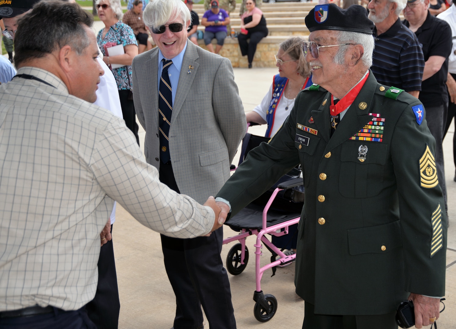Retired Command Sgt. Maj. Felipe O’Bryan receives an official Vietnam lapel pin at the end of the ceremony for the 50th Anniversary of the Commemoration of the Vietnam War at the Fort Sam Houston National Cemetery March 27.