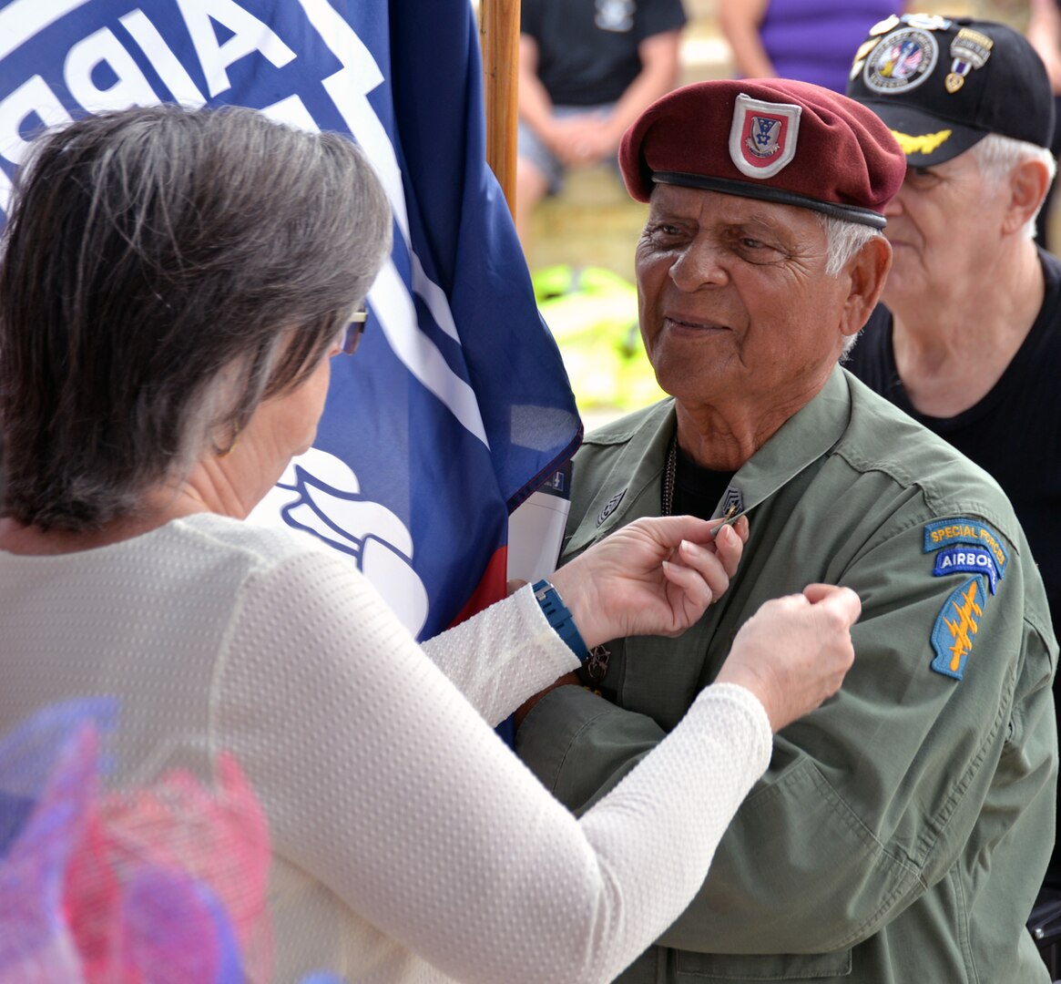 A retired Army Special Forces sergeant major steps up to receive his Vietnam service lapel pin at the conclusion of the 50th Anniversary of the Commemoration of the Vietnam War at the Fort Sam Houston National Cemetery March 27.