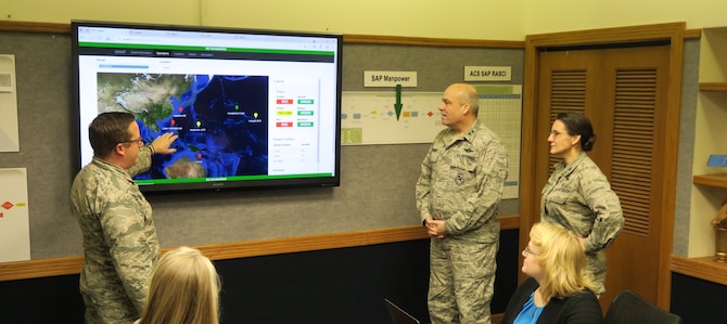 (From left to right) Major Nick Kirsch, Maj. Gen. Michael Brewer and Col. Francesca Bartholomew of Air Force Materiel Command review the analysis from an ISWAT scenario.  The new ISWAT technology, developed by an Ohio company with support from the Air Force SBIR/STTR Program technology, provides a more realistic impact of logistics in long-term conflicts. (Air Force photo)