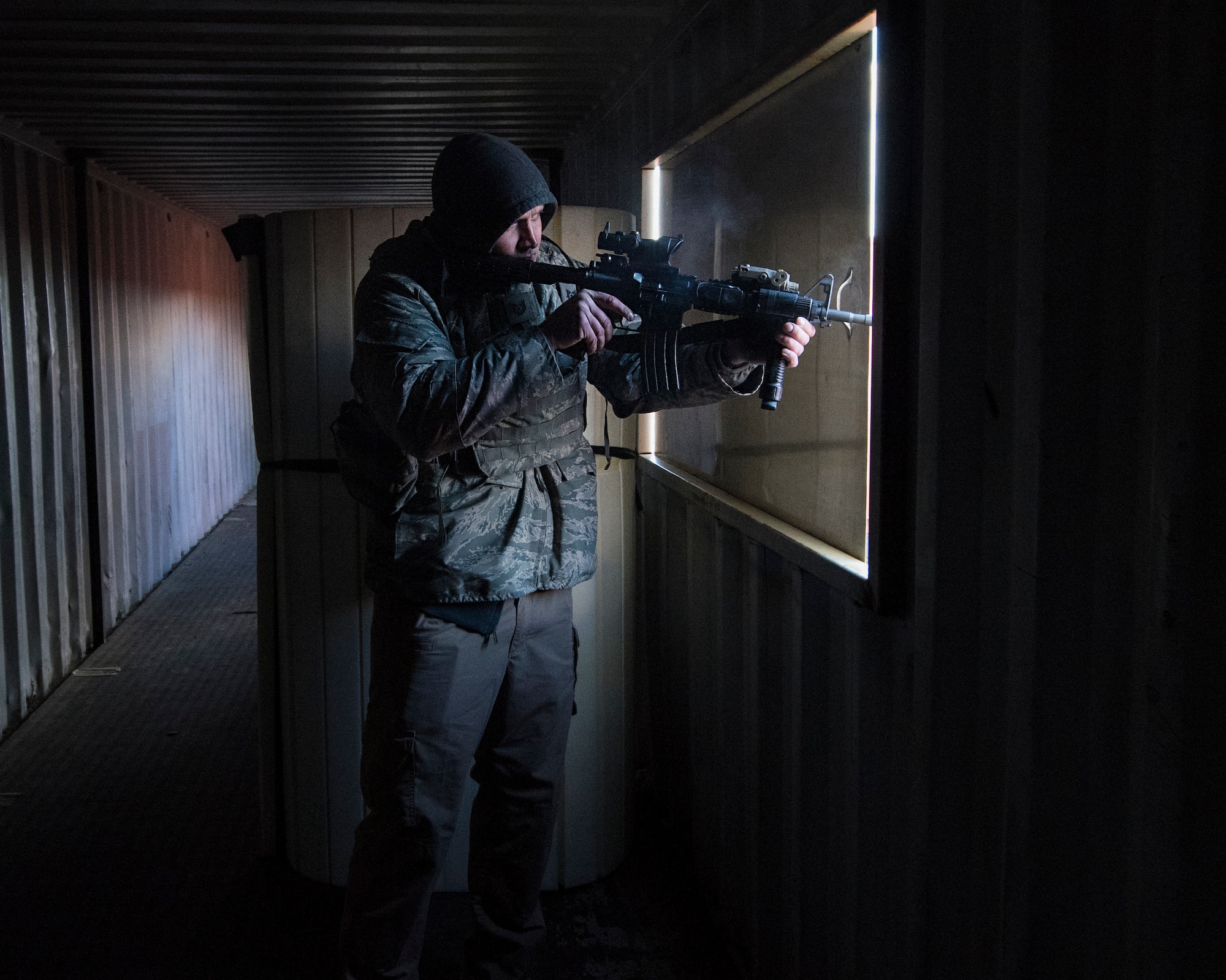 Tech. Sgt. Ryan Krastins, 141st Security Forces Squadron security forces specialist, plays the role of the opposing force during a field training exercise at the Urban Evasion Laboratory March 9, 2018 at Fairchild Air Force Base, Wash. The Guardsmen practiced several training scenarios while conducting the training to include moving a squad within the UEL to secure the area from hostile forces in order to set up a bare base of operations. (U.S. Air National Guard photo by Staff Sgt. Rose M. Lust)