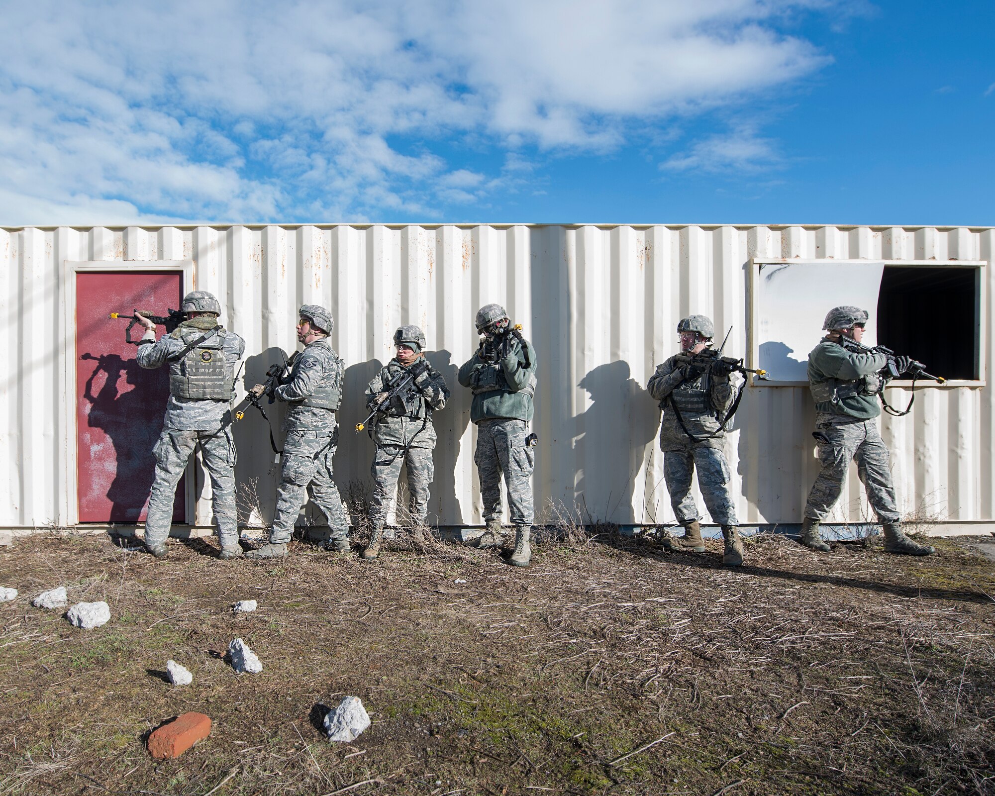 A fire team of security forces specialists with the 141st Security Forces Squadron search an area of the Urban Evasion Laboratory during a troop movement amid training March 9, 2018 at Fairchild Air Force Base, Wash. The Guardsmen were focusing on enhancing their skills in areas like communication, operations in urban terrain, and mounted and dismounted patrolling. (U.S. Air National Guard photo by Staff Sgt. Rose M. Lust)