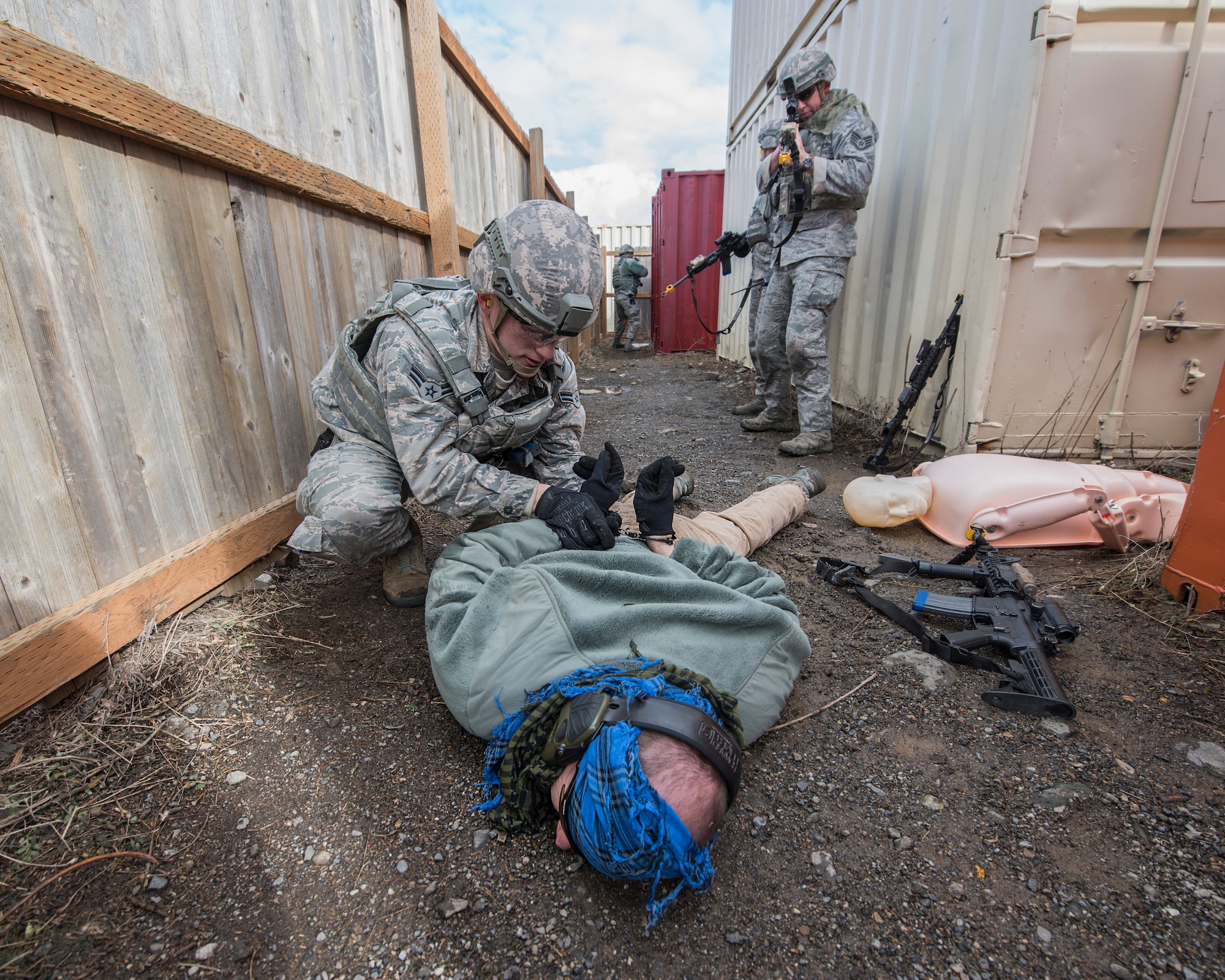 Airman 1st Class Christopher Aston, 141st Security Forces Squadron security forces specialist, detains a member of the opposing force during a field training exercise at the Urban Evasion Laboratory March 9, 2018 at Fairchild Air Force Base, Wash. The Guardsmen were focusing on enhancing their skills in areas like communication, operations in urban terrain, and mounted and dismounted patrolling. (U.S. Air National Guard photo by Staff Sgt. Rose M. Lust)