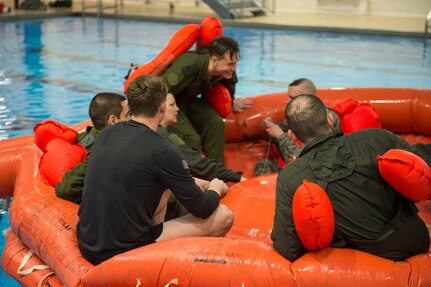 Survival, evasion, resistance and escape specialists with the 3rd Operations Support Squadron conduct a water-survival refresher course for pilots and aircrew at the Elmendorf Fitness Center on Joint Base Elmendorf-Richardson, Alaska, March 20, 2018. The course consisted of safely escaping from under a parachute, using recovery tools, simulating a parachute drag, and various other techniques.