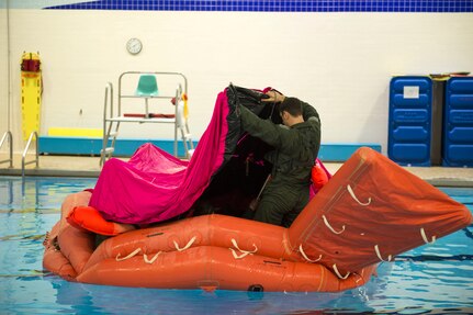 Survival, evasion, resistance and escape specialists with the 3rd Operations Support Squadron conduct a water-survival refresher course for pilots and aircrew at the Elmendorf Fitness Center on Joint Base Elmendorf-Richardson, Alaska, March 20, 2018. The course consisted of safely escaping from under a parachute, using recovery tools, simulating a parachute drag, and various other techniques.