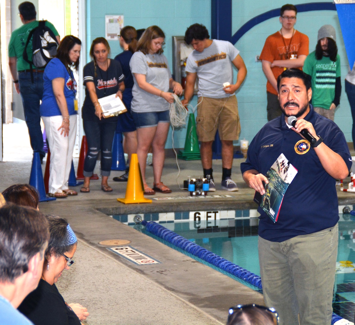 Juan P. Rodriguez, an education services specialist assigned to Navy Recruiting District San Antonio, welcomes teams, coaches and parents to the Georgetown SeaPerch Underwater Robotics Challenge Regional Competition held at the Georgetown Recreation Center. The Navy Recruiting Command Southwest Region City Outreach Program, in cooperation with the Georgetown Independent School District and NRD San Antonio, hosted the regional qualifier. The competition consisted of three evolutions: speed obstacle course, challenge course and interview/presentation.