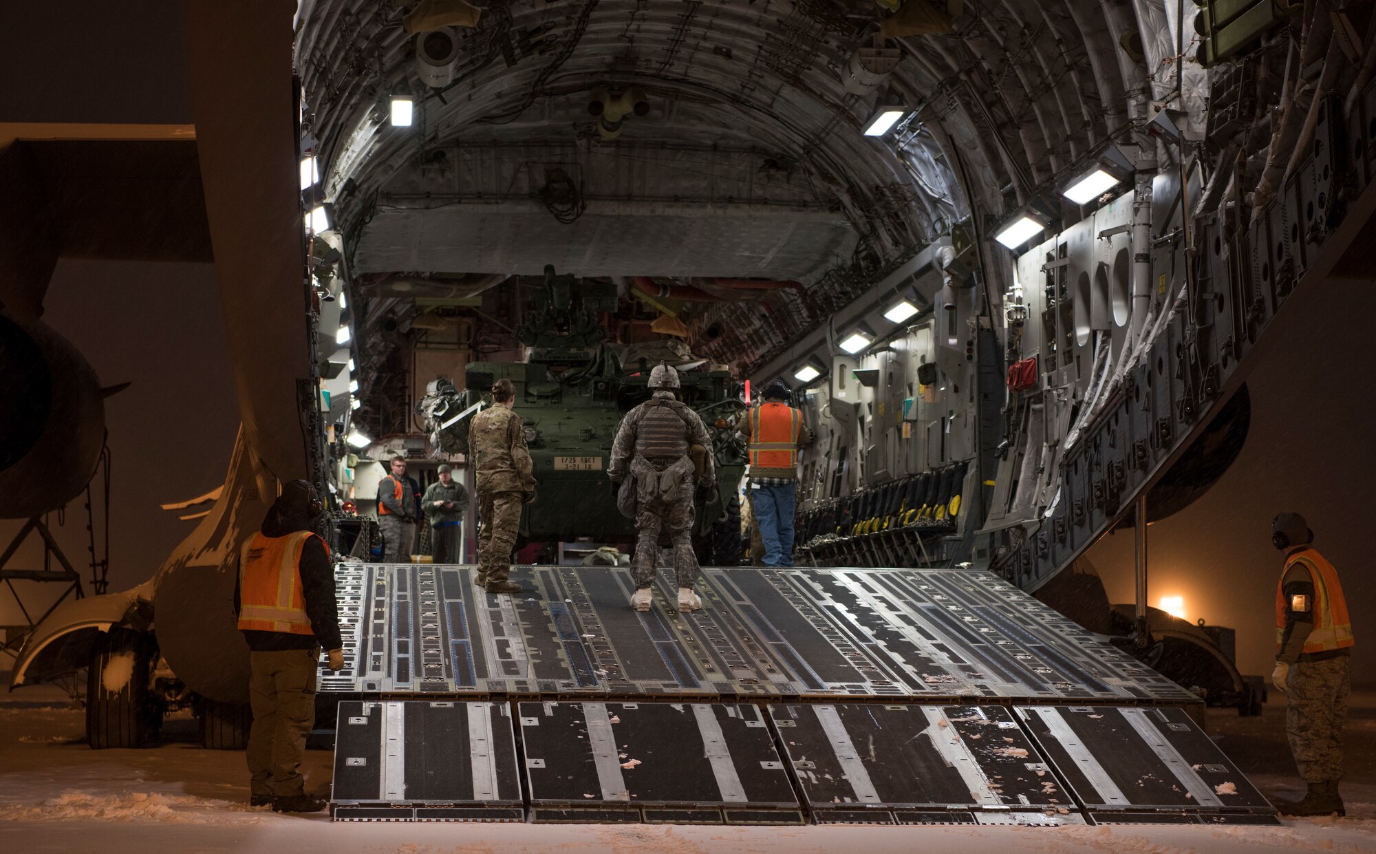 U.S. Air Force Airmen and U.S. Army Soldiers work together to load an Interim Armored Vehicle Stryker into a C-17 Globemaster III during Exercise Artic Pegasus at Elmendorf Air Force Base, Alaska, March 13, 2018. The purpose of the exercise was to practice cold-weather operations in Deadhorse, Alaska. (U.S. Air Force photo by Senior Airman Tryphena Mayhugh)