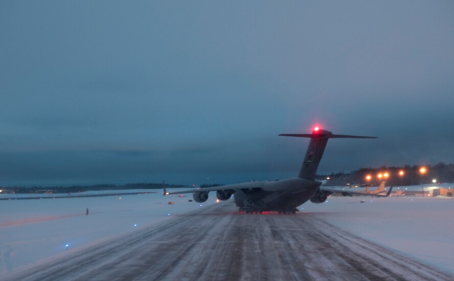 A C-17 Globemaster III taxis to a runway during Exercise Arctic Pegasus at Elmendorf Air Force Base, Alaska, March 13, 2018. The 62nd Airlift Wing sent two C-17s to deliver Army personnel and Strykers to Deadhorse, Alaska, during the exercise. (U.S. Air Force photo by Senior Airman Tryphena Mayhugh)