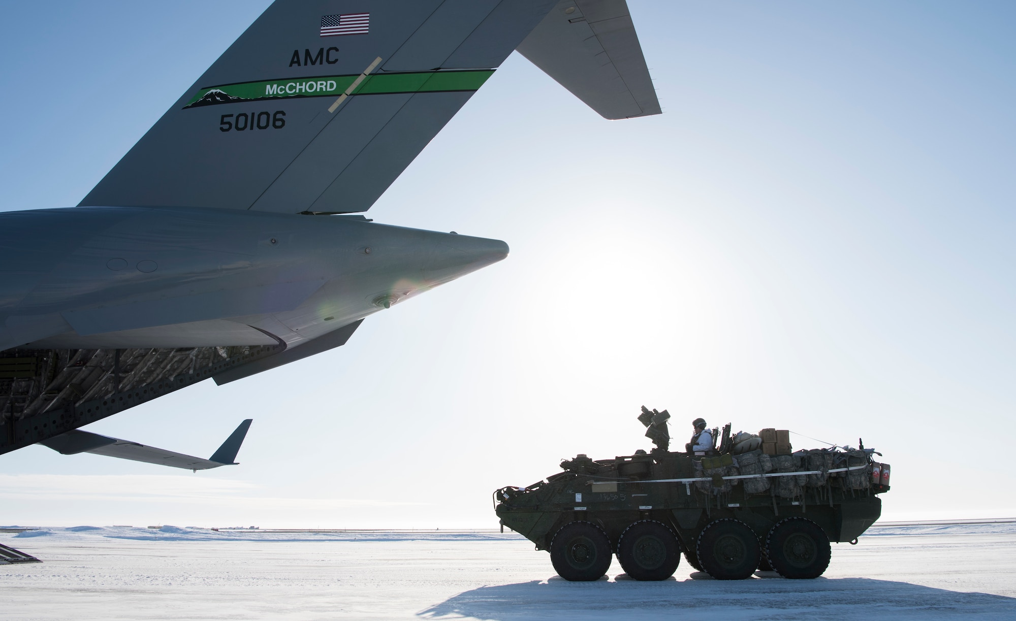 A U.S. Army Soldier drives an Interim Armored Vehicle Stryker onto a C-17 Globemaster III during Exercise Arctic Pegasus at Deadhorse, Alaska, March 13, 2018. Airmen assigned to the 62nd Airlift Wing flew two C-17 Globemaster IIIs to deliver Army Soldiers and four Strykers to Deadhorse for the exercise. (U.S. Air Force photo by Senior Airman Tryphena Mayhugh)