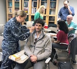 Cmdr. Janel Rossetto practices needle placement for battle field acupuncture on Dr. Adam Lang during the Clinical Pharmacy Course, or CPC, at the U.S. Army Medical Department Center & School at Joint Base San Antonio-Fort Sam Houston during the third week of March 2018.