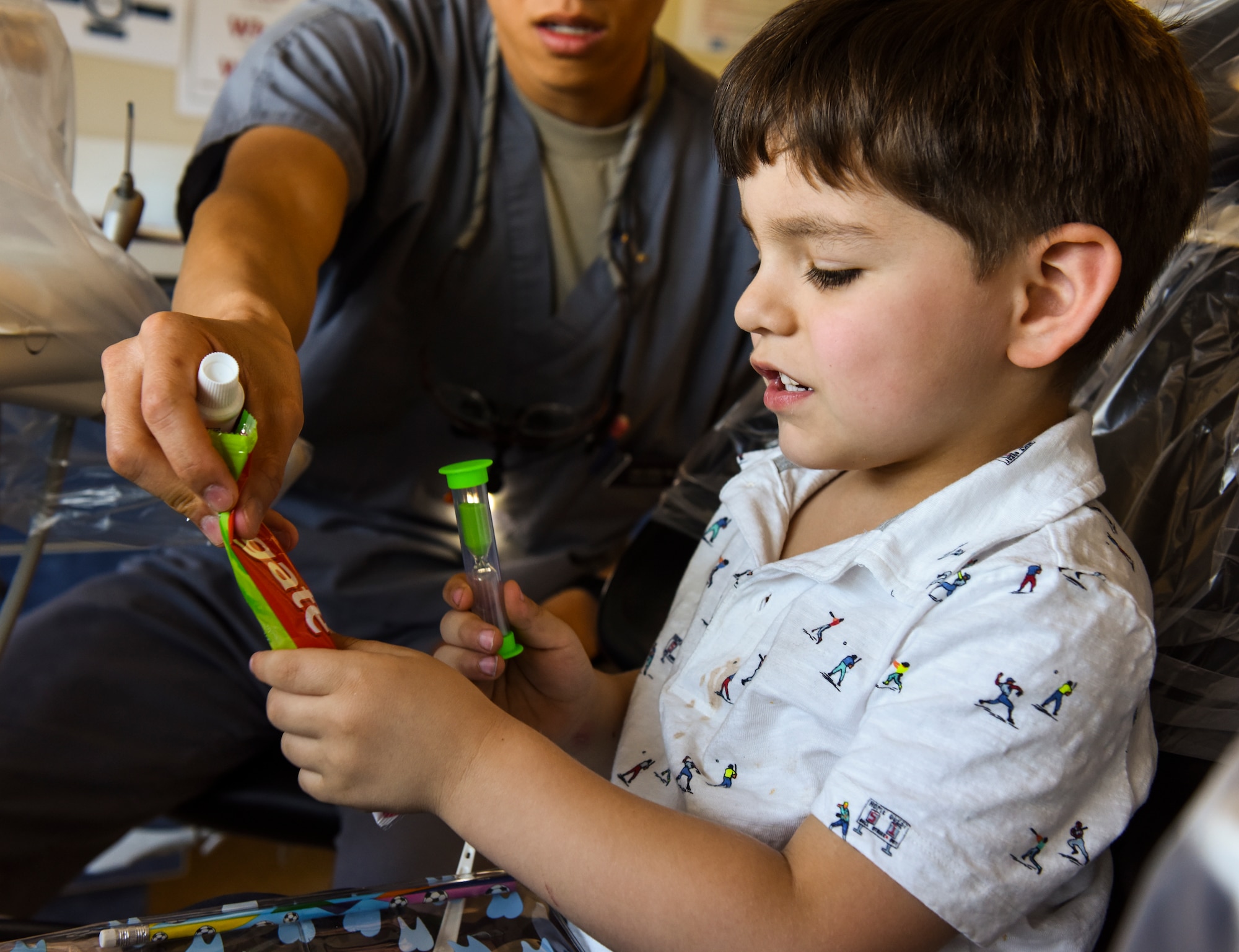 Vincent, a patient participating in the Give Kids A Smile program, looks through his dental ‘goody bag’ at Joint Base Charleston, S.C., March 23, 2018.