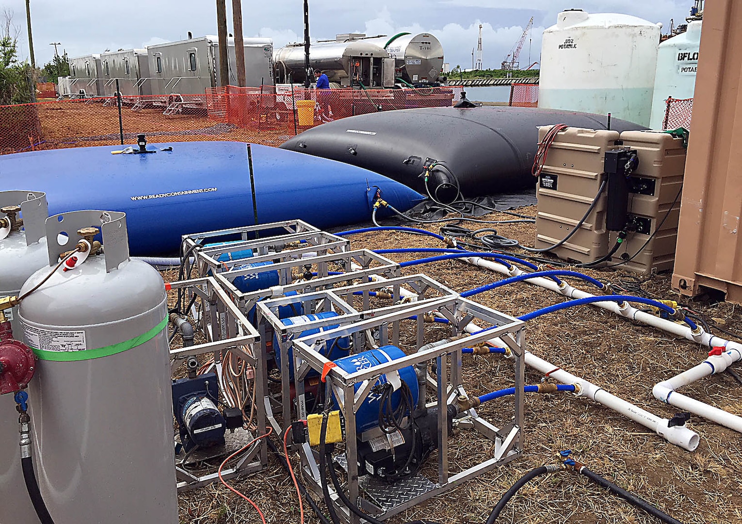 Shown are bulk water storage bladders to support showers, latrines, a dining facility and the laundry facility at the LOGCAP Roosevelt base camp in Puerto Rico Oct. 27. The base camp required up to 50,000 gallons of water hauled daily by trucks to sustain camp operations.