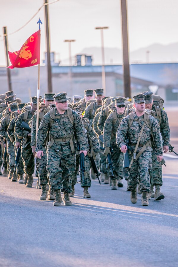 Major Alfredo Romero,  Head quarters Company commanding officer (left) marches with 1st Sgt. Neil Roselli, HqCo 1st Sgt., during a conditioning hike with the company Marines aboard Marine Corps Logistics Base Barstow, Calif., March 16.