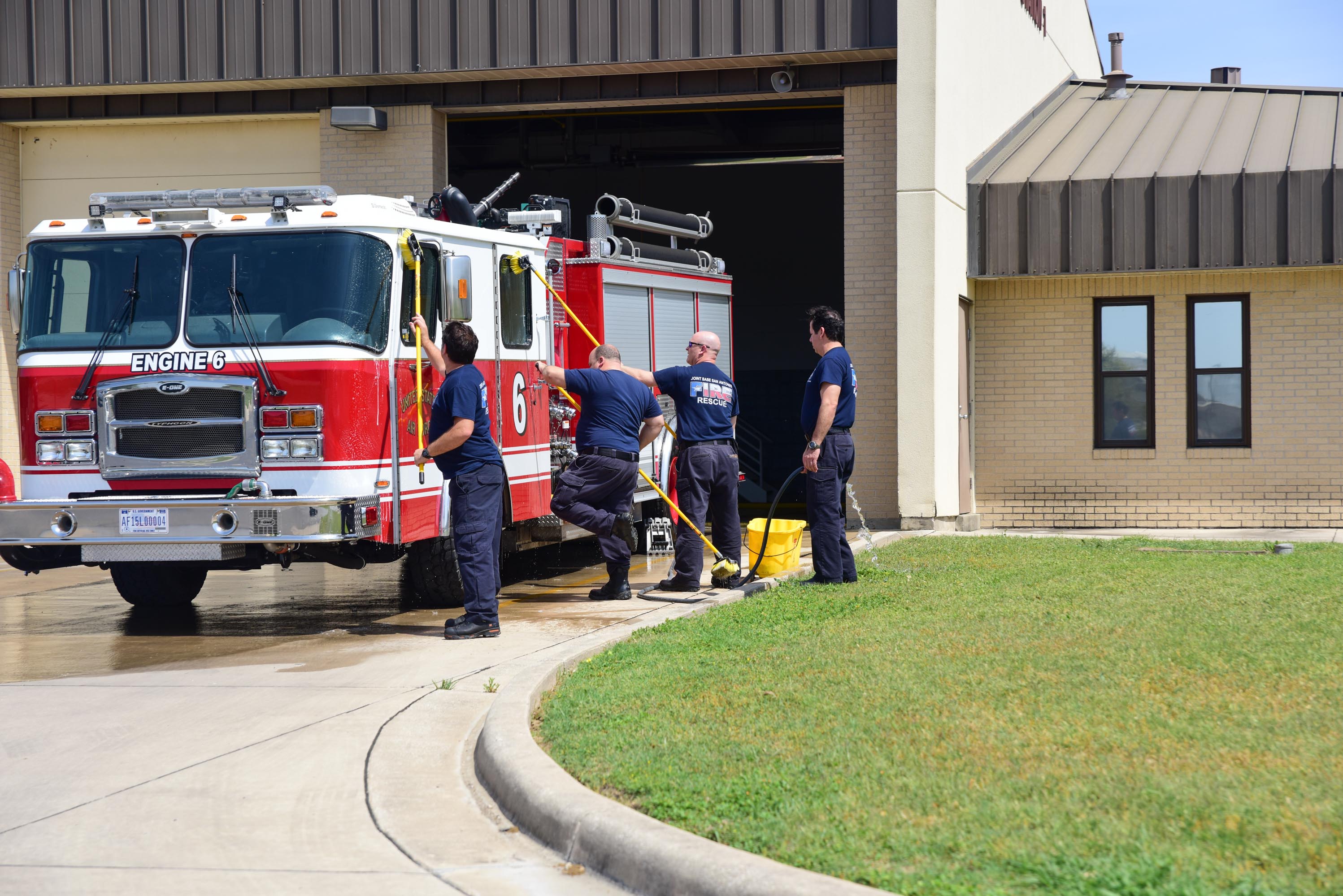 Jbsa 502nd Fire Rescue Personnel Clean Vehicle On Sunny Afternoo