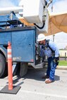 A 502nd Civil Engineer squadron high voltage team re-attaches the cover at medina base gate