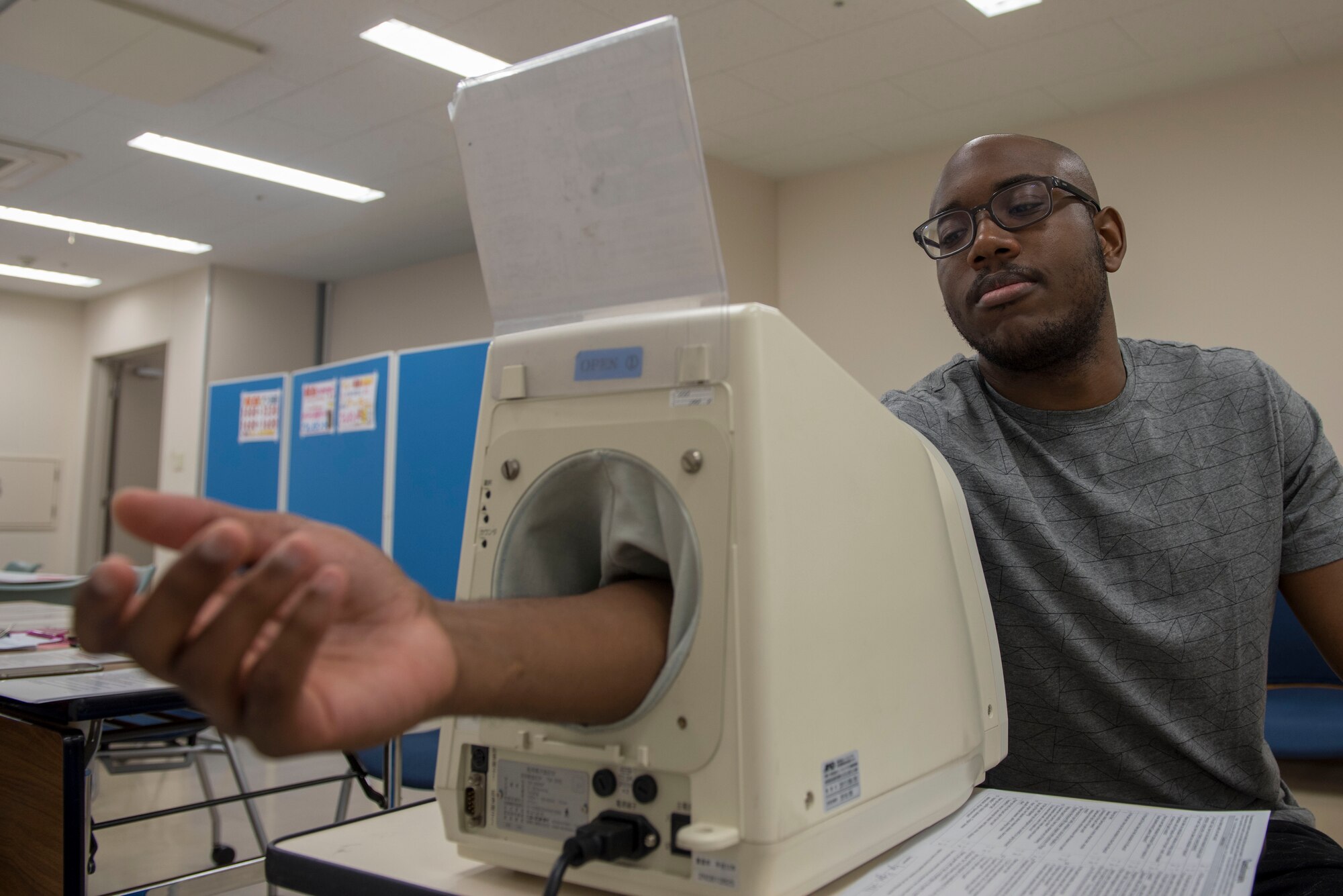 Senior Airman Ryan Higgins Dodd, 374th Logistics Readiness Squadron fuels distribution operator, has his blood pressure checked as part of a medical prescreening prior to donating blood to the Japanese Red Cross Society at Yokota Air Base, Japan, March 28, 2018.