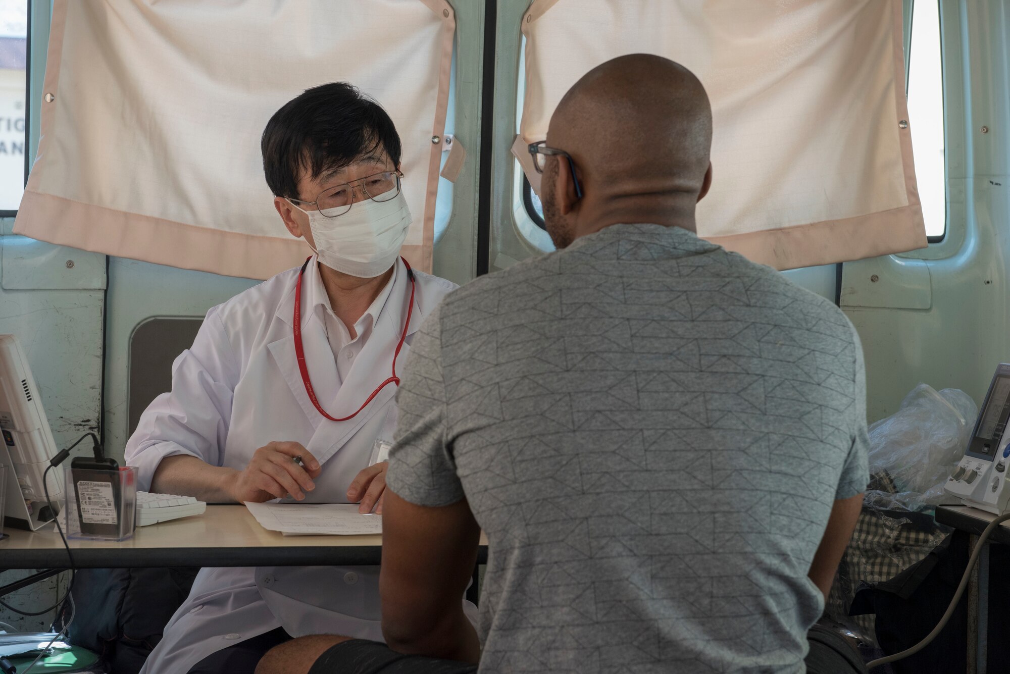 Senior Airman Ryan Higgins Dodd, 374th Logistics Readiness Squadron fuels distribution operator, meets with a certified physician as the final portion of his medical prescreening prior to donating blood to the Japanese Red Cross Society at Yokota Air Base, Japan, March 28, 2018.