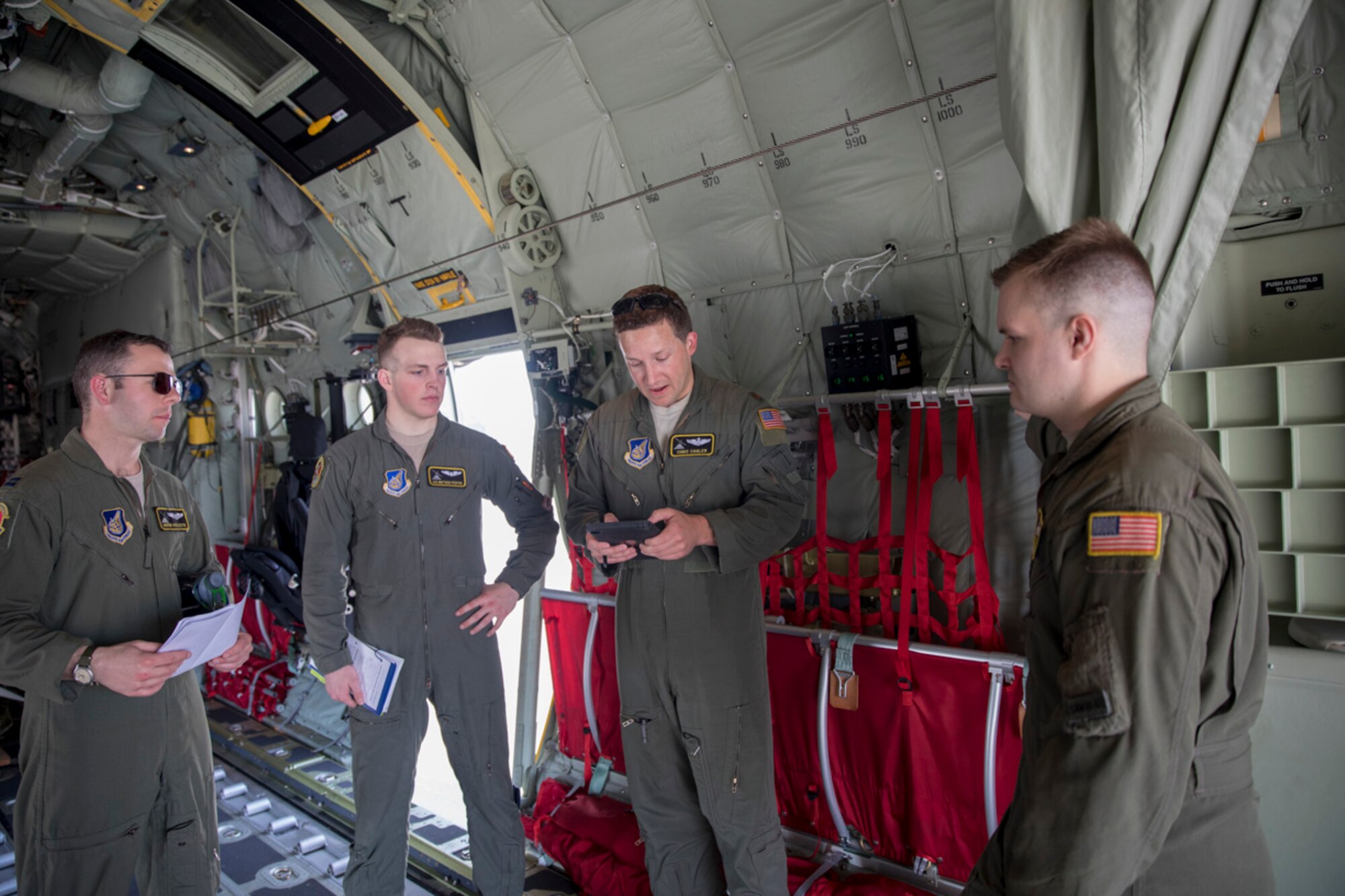 Maj. Christopher Carlen (center), 36th Airlift Squadron C-130J pilot, gives a pre-flight briefing