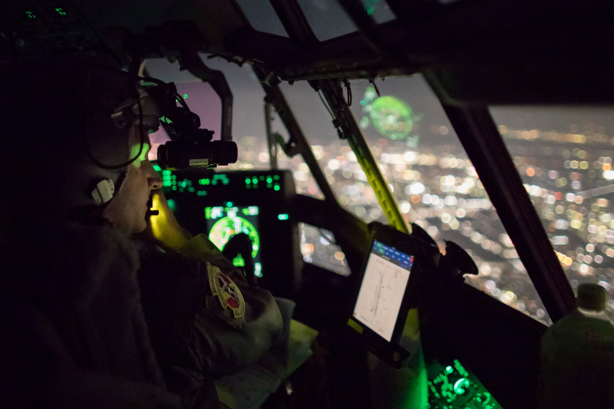 Maj. Christopher Carlen, 36th Airlift Squadron C-130J pilot, performs a visual confirmation with night vision goggles during a training mission over the Kanto Plain