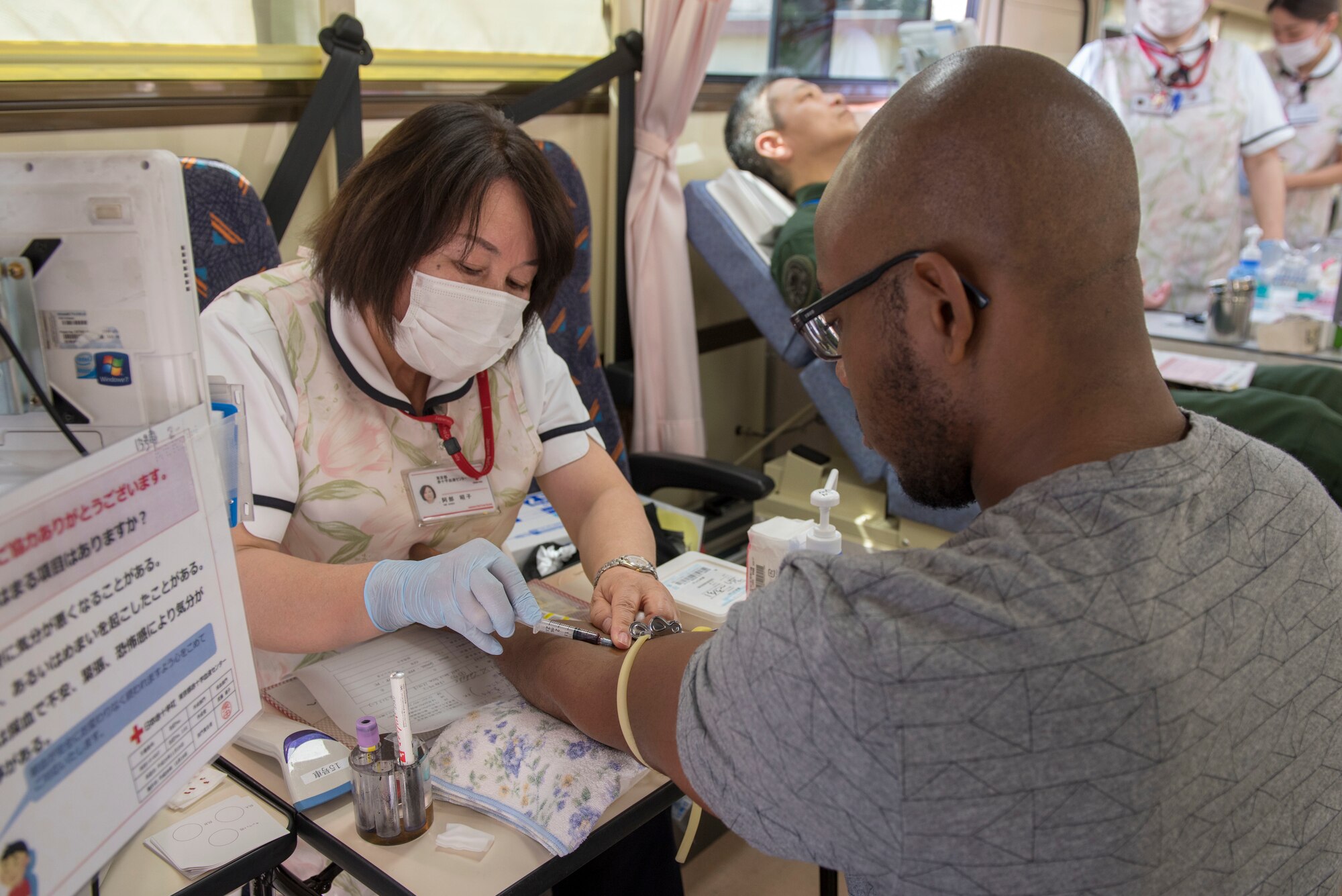 Senior Airman Ryan Higgins Dodd, 374th Logistics Readiness Squadron fuels distribution operator, begins the initial process of donating blood to the Japanese Red Cross Society at Yokota Air Base, Japan, March 28, 2018.
