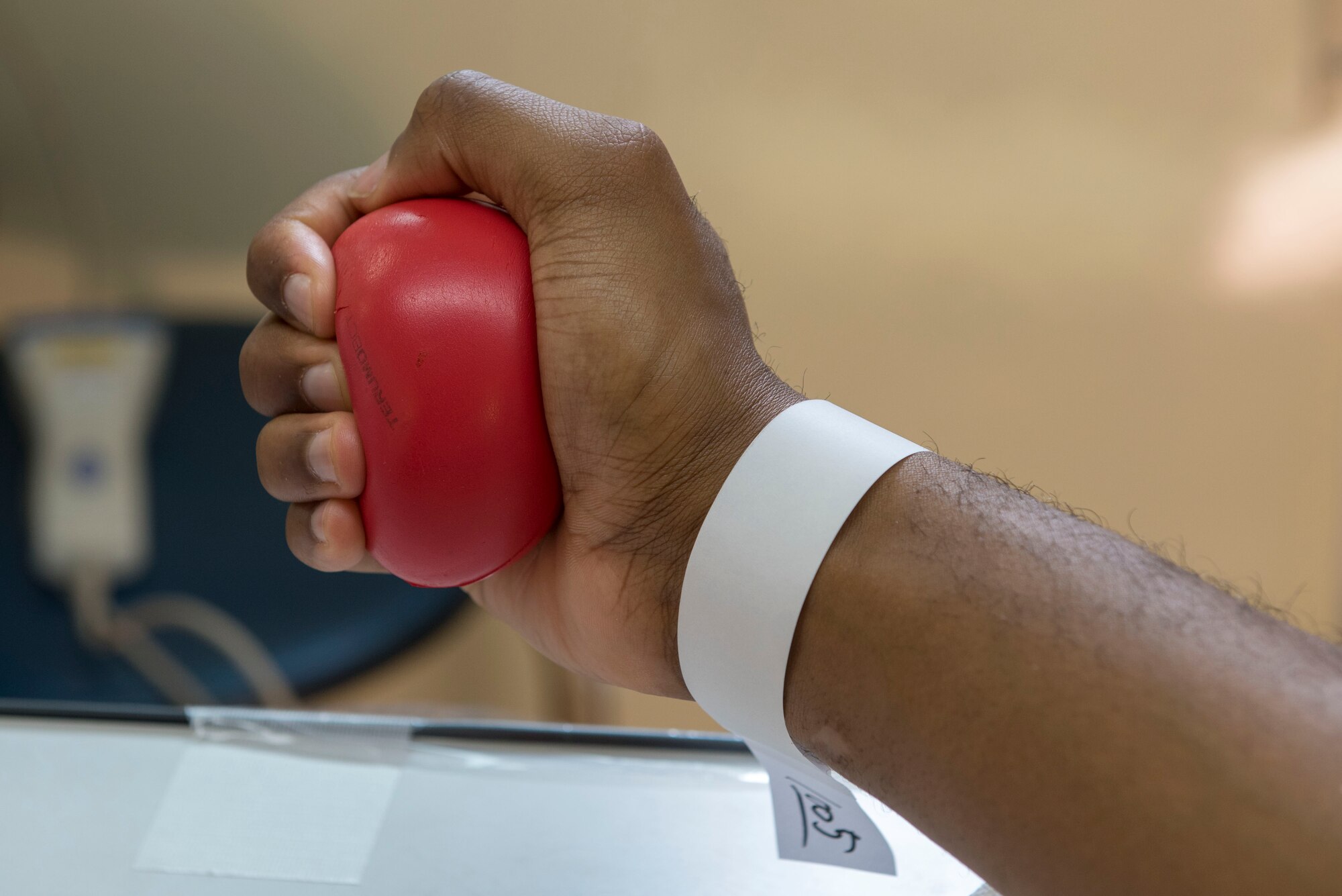 Senior Airman Ryan Higgins Dodd, 374th Logistics Readiness Squadron fuels distribution operator, squeezes a stress ball while donating blood to the Japanese Red Cross Society at Yokota Air Base, Japan, March 28, 2018.