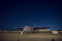 An Air Force C-130J Super Hercules parks on the flightline after returning a night training mission at Yokota Air Base