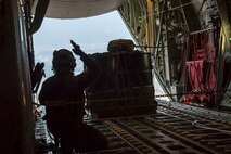 Airman 1st Class Matthew Pfeffer, 36th Airlift Squadron C-130J loadmaster, performs a Container Delivery System (CDS) bundle airdrop over Combined Arms Training Center Camp Fuji