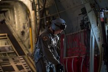 Airman 1st Class Matthew Pfeffer, 36th Airlift Squadron C-130J loadmaster, secures his harness before conducting Container Delivery System (CDS) bundle airdrops over Combined Arms Training Center Camp Fuji, Japan