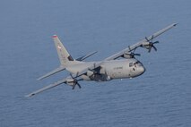 A U.S. Air Force C-130J Super Hercules assigned to the 36th Airlift Squadron flies over Suruga Bay